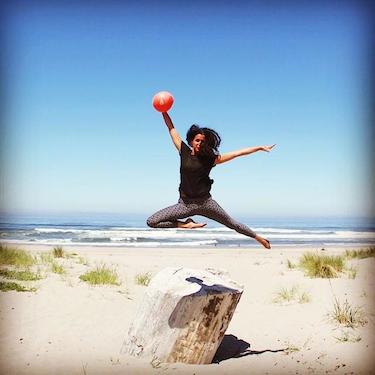 Liz Richards, Acupuncturist and Blossom owner, taking a leap with her barre3 core ball.